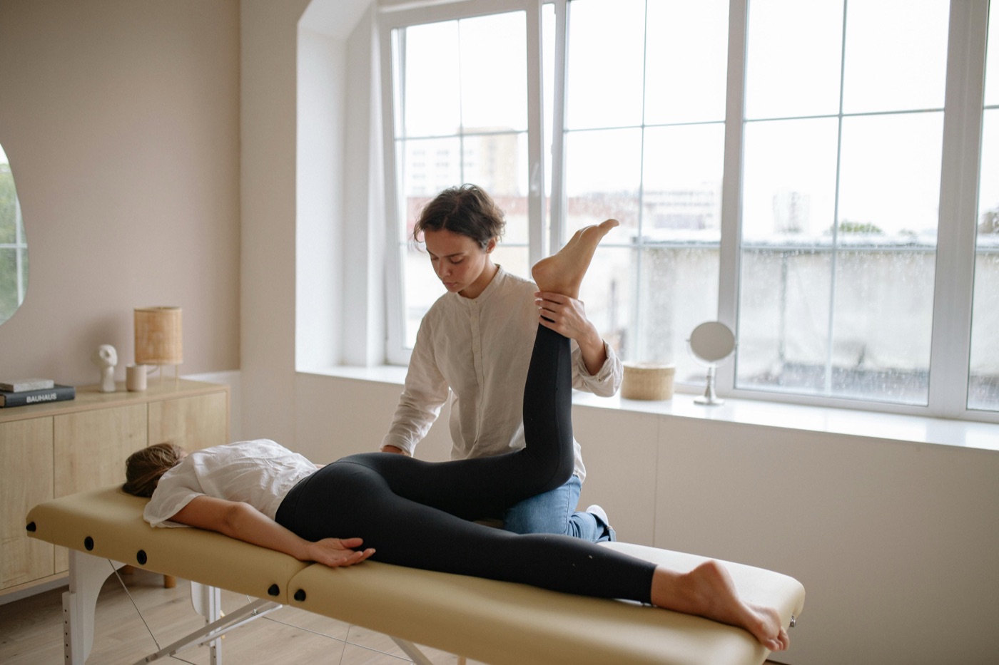 A physical therapist guiding a patient through a stretch